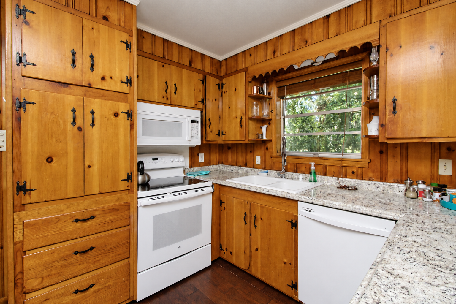 Rustic wood kitchen with granite counters and sunny window views
