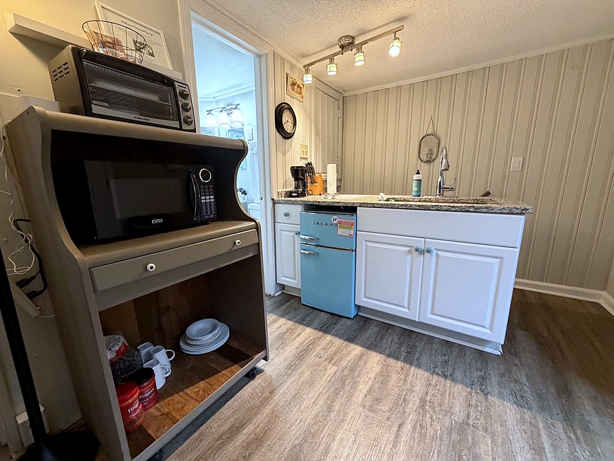 Charming kitchenette with retro mini fridge, coffee station, and modern finishes