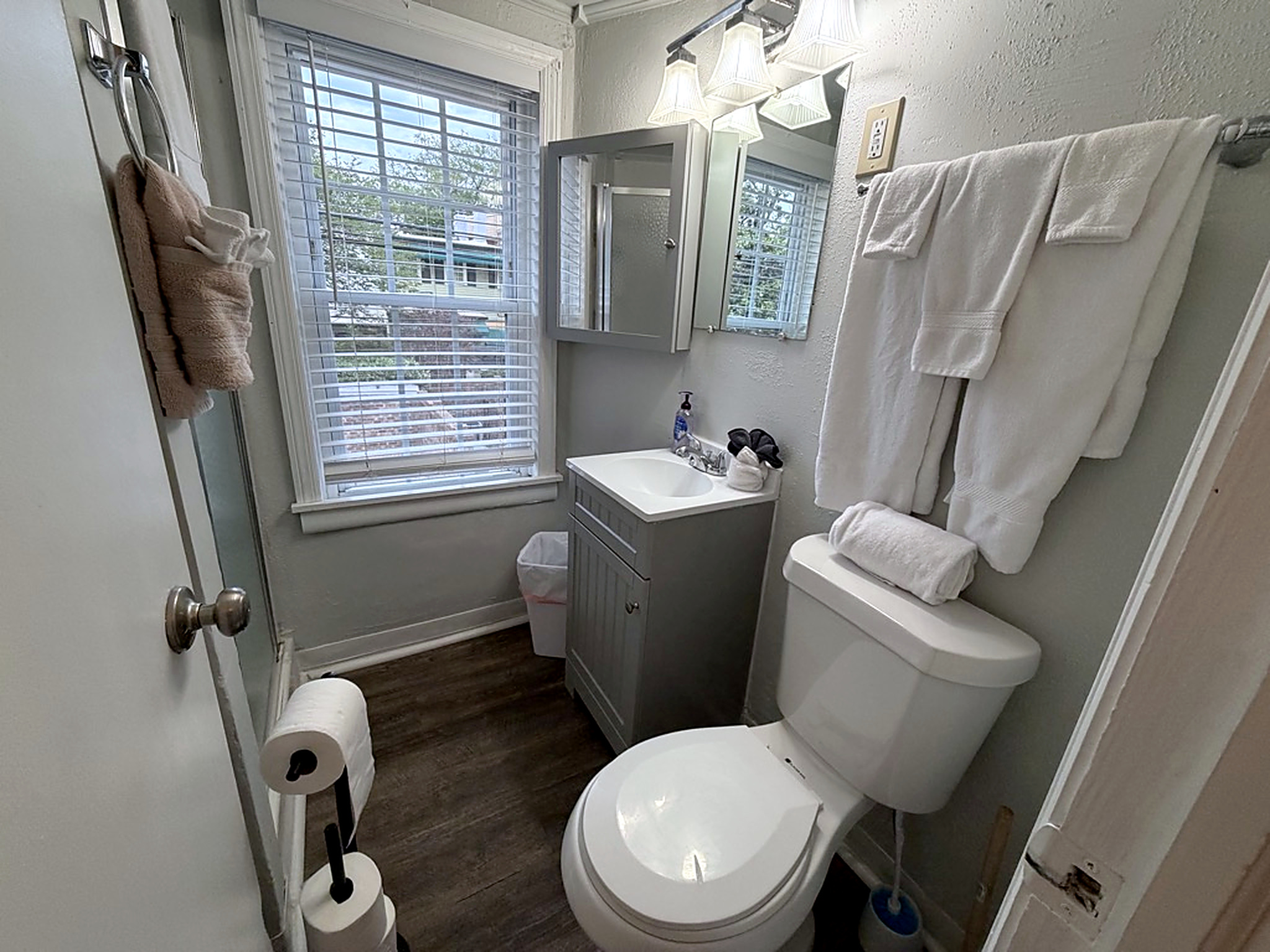 Bright, tidy bathroom with natural light and modern gray vanity