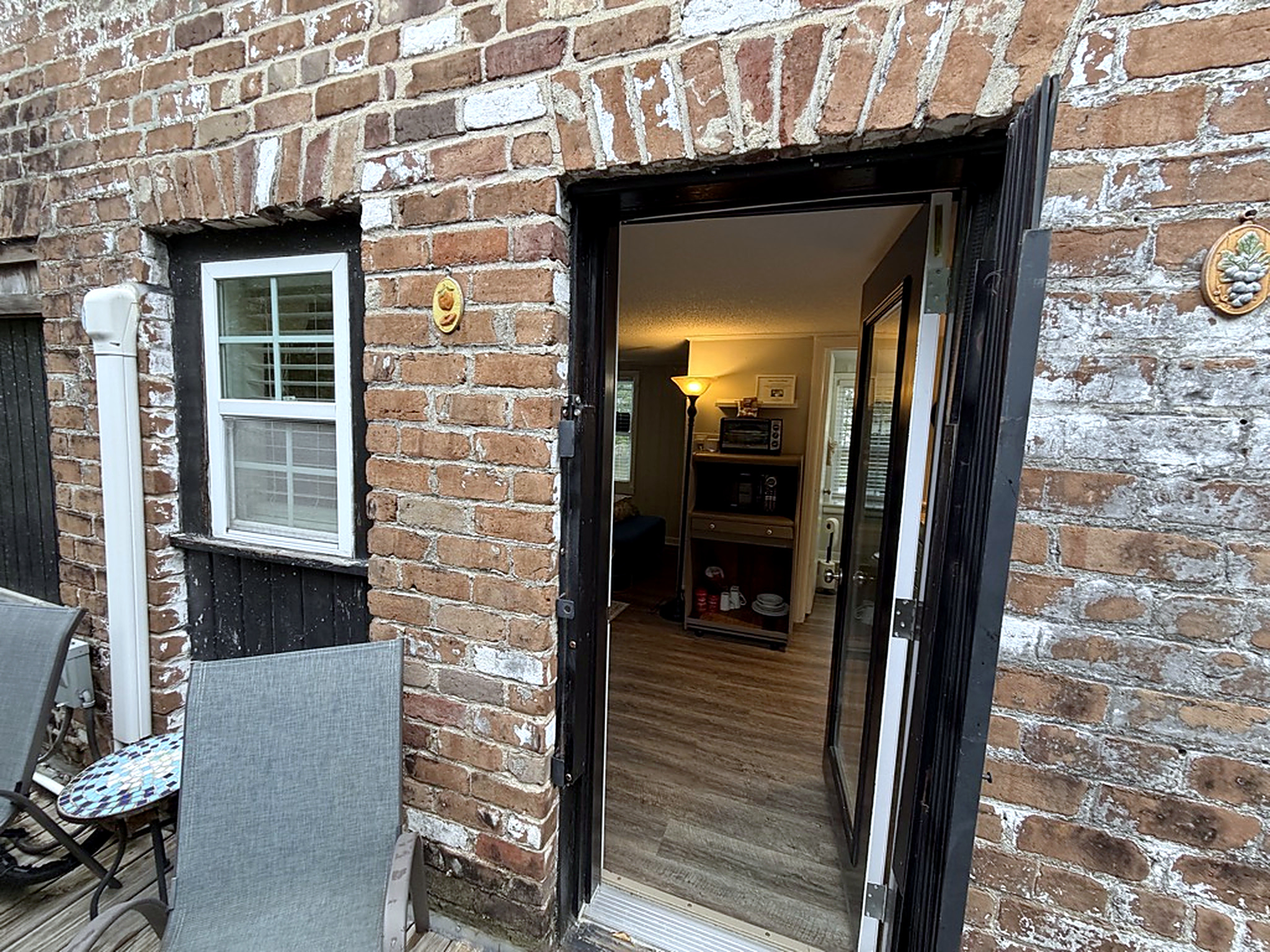 Historic brick entry with cozy indoor charm and patio seating