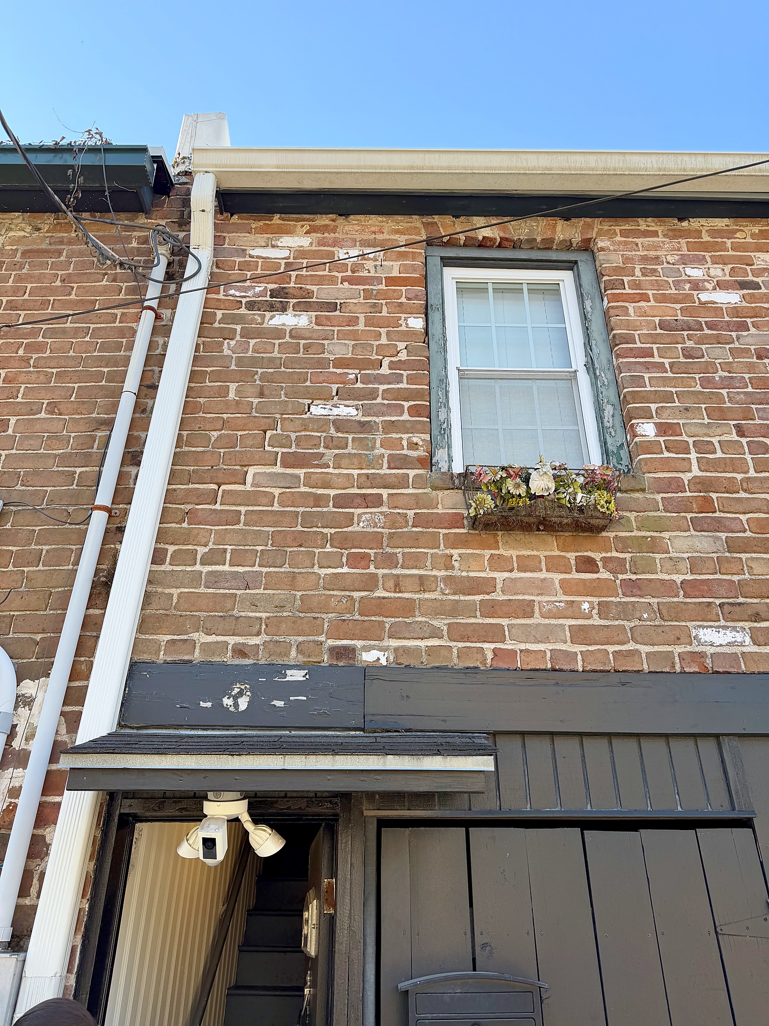 Charming brick townhouse exterior with flower box and historic character
