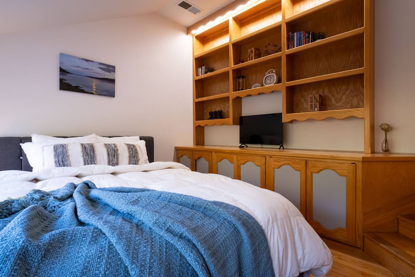 Relax in the cozy downstairs queen bedroom, complete with a TV for easy nights in.