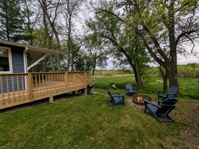 Backyard with fire pit, Adirondack chairs and deck