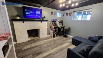 Game room with Pac-Man and Golden Tee arcades and a TV