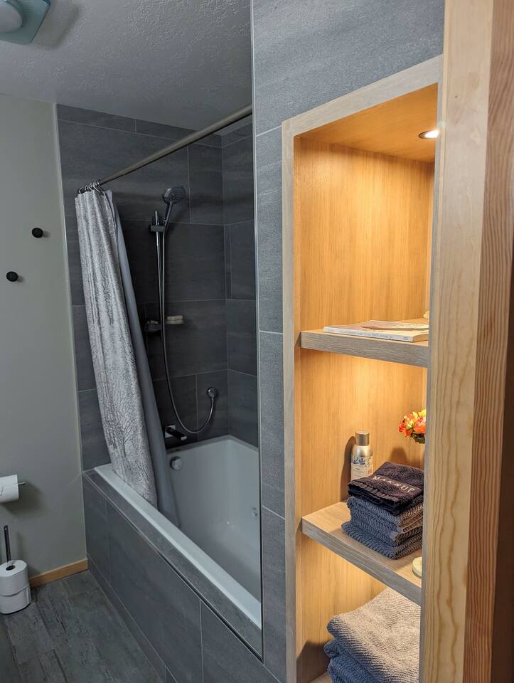 Enjoy a relaxing soak with plush towels and calming touches all within reach.