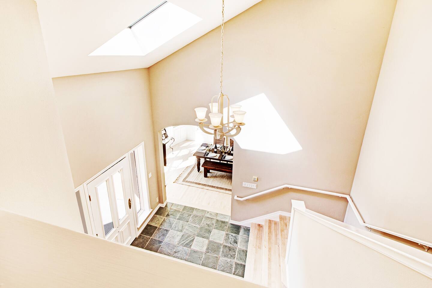 Step into a space kissed by daylight—warm wood underfoot, cool tile below, and quiet elegance all around.