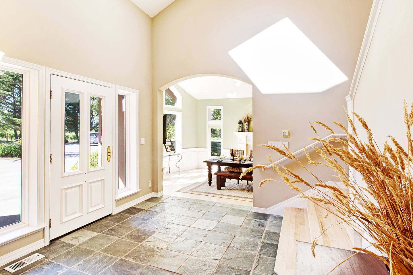 Step into a space kissed by daylight—warm wood underfoot, cool tile below, and quiet elegance all around.