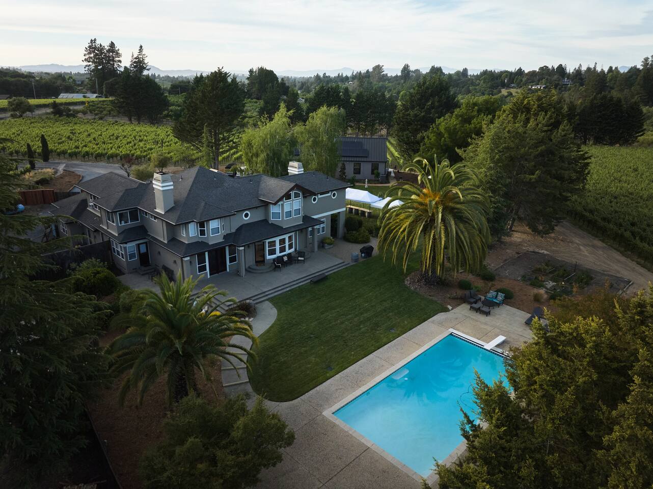 The scent of sun-warmed vines, the hush of distant trees, and the shimmer of poolside serenity—this is Wine Country, wrapped in stillness and space.