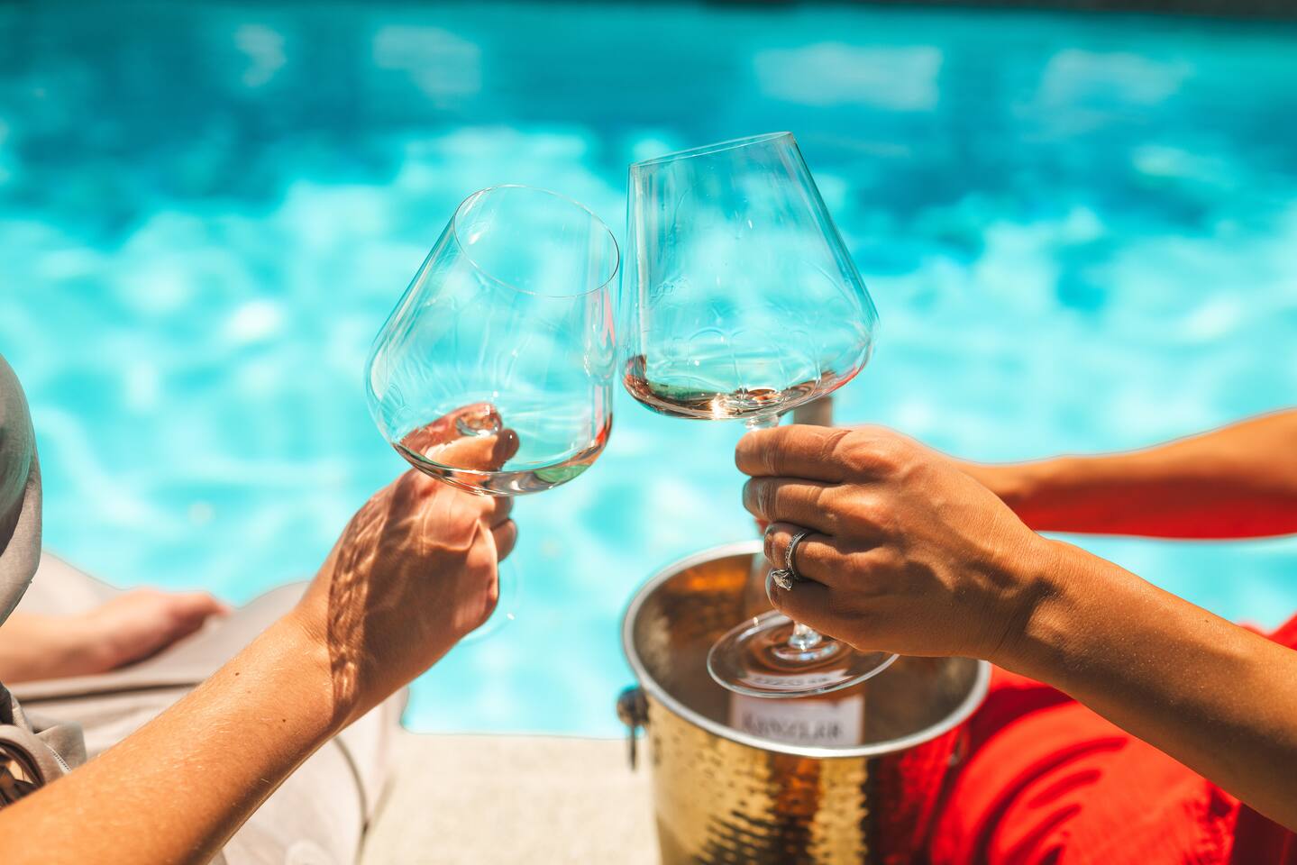 Linger poolside with a glass of local wine and your feet in the water.