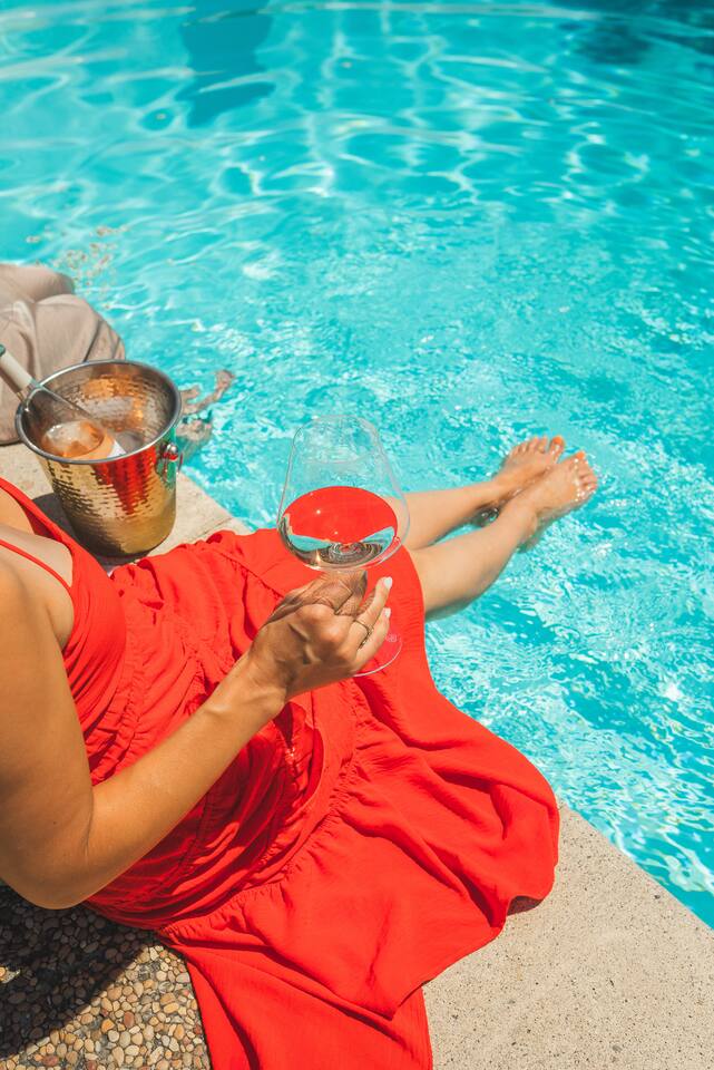 Linger poolside with a glass of local wine and your feet in the water.