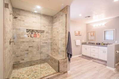 Luxury Ensuite Bathroom!  Experience pure comfort in this spa-like bath. Features a huge walk-in shower with a glass door, custom tile, and a built-in bench. Enjoy the large double vanity with quartz counters. Pebble floor adds a custom touch!