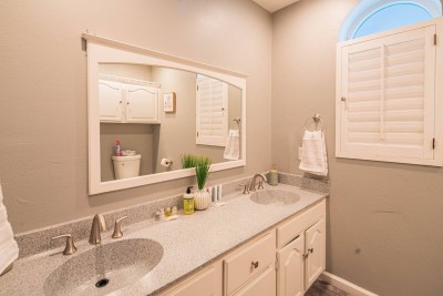 Spacious Double Vanity Full Bath!  This bright bathroom features a large double vanity with ample granite counter space. Enjoy the charming window with plantation shutters and a neutral, calming color palette.