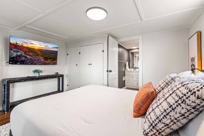 The lower level queen bed is just step to its own bathroom.