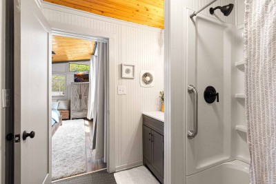 This is the master bathroom.  Penny tile on the floor and a spruce ceiling.