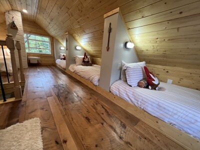 Cozy wood-lined loft with built-in twin beds for a fun group stay