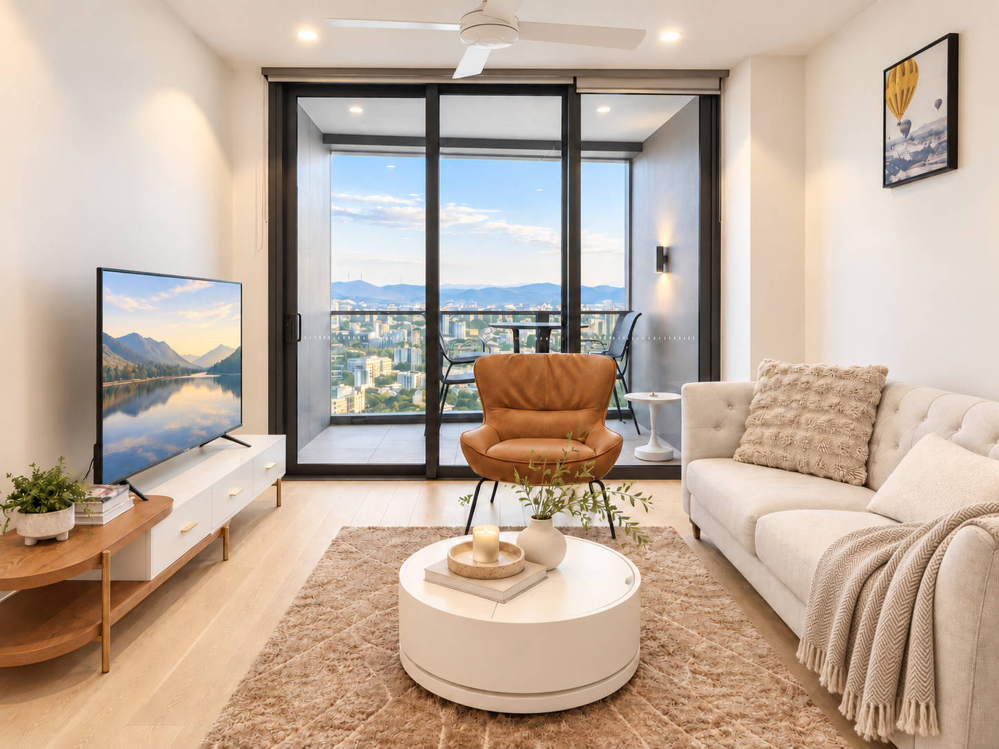 Bright modern lounge with private balcony and stunning city-mountain views