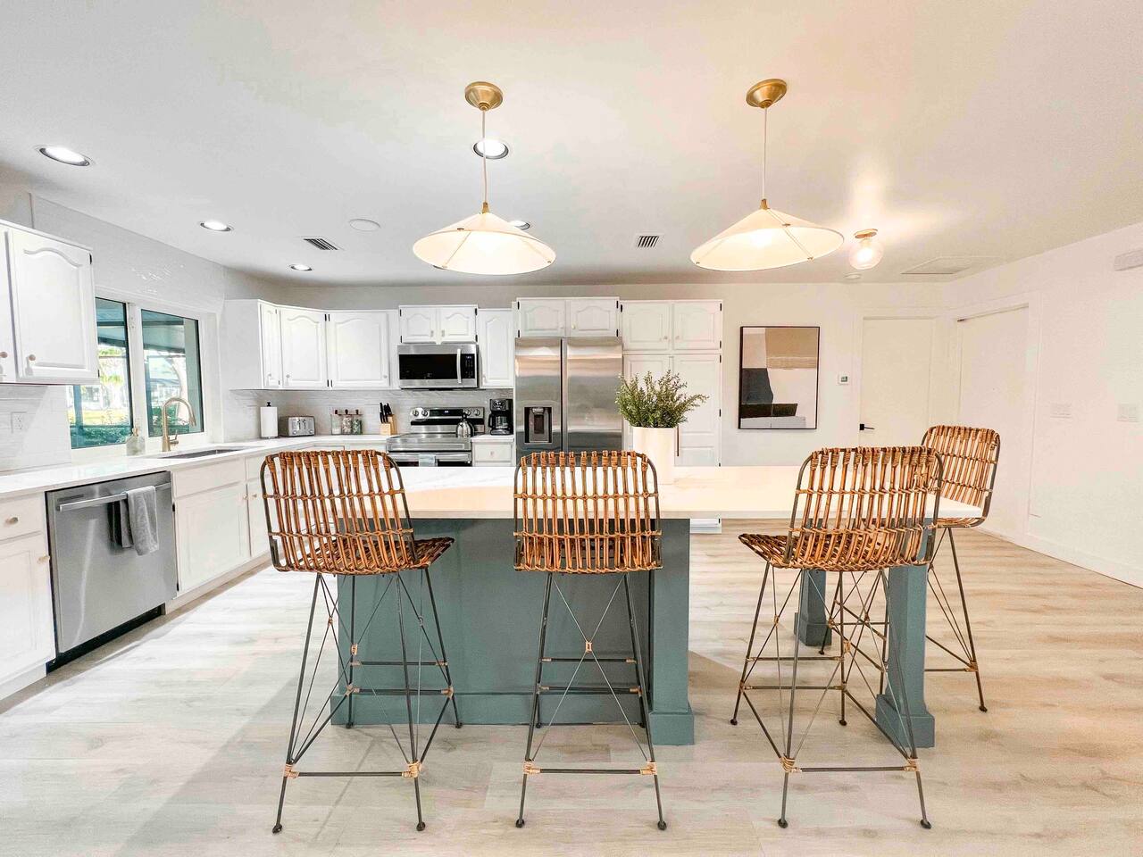Kitchen w/ 7ft Island and Stainless Steel Appliances. Stocked with dish-ware, coffee, tea, spices.