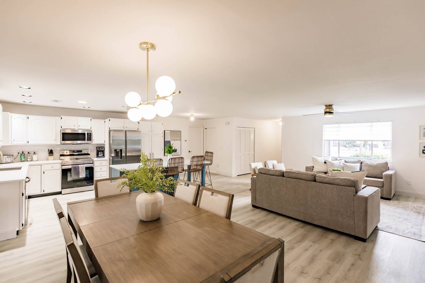 Large kitchen dining table with beautiful views of the pool and lake.