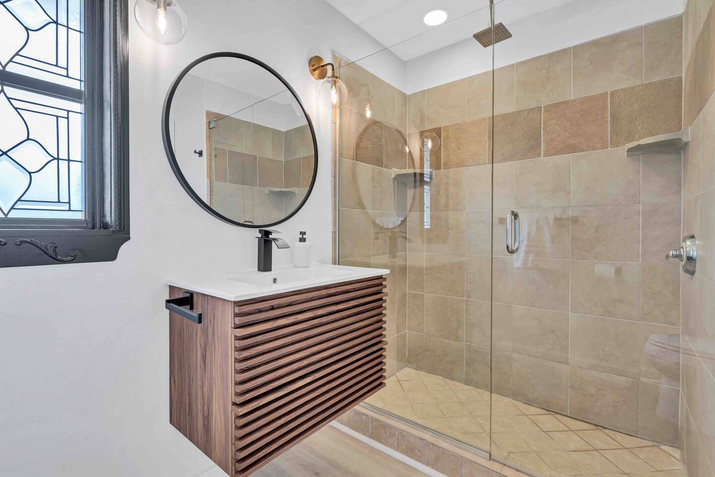 Hall Bathroom with tiled walk-in shower and floating vanity.