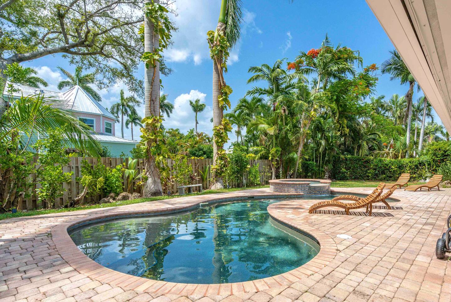 Spectacular pool and spa. Featuring fountains, baja shelf, and in pool seating. Surrounded by lush trees and landscaping.
