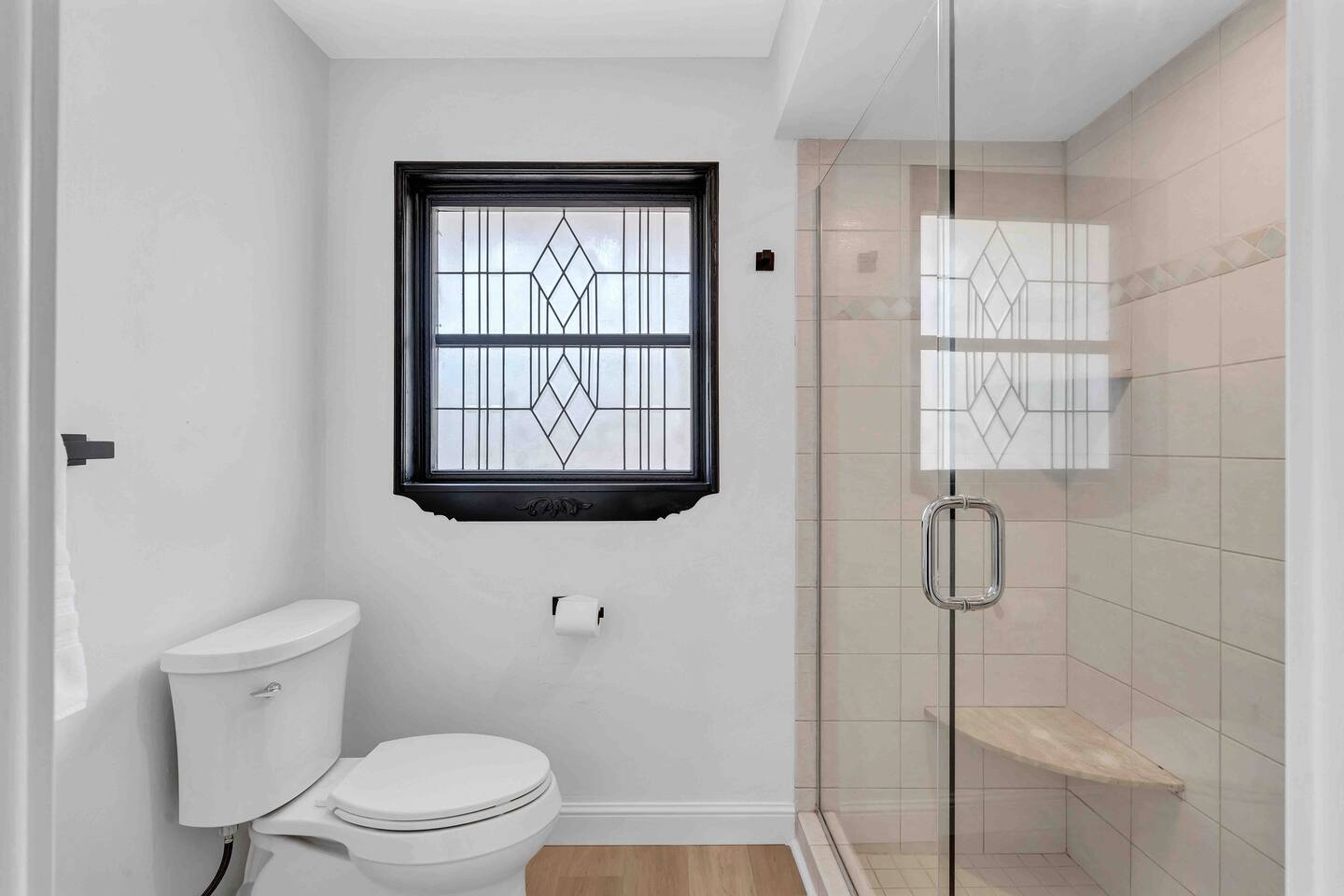 Primary Suite Bathroom. Tile shower with shaving bench.