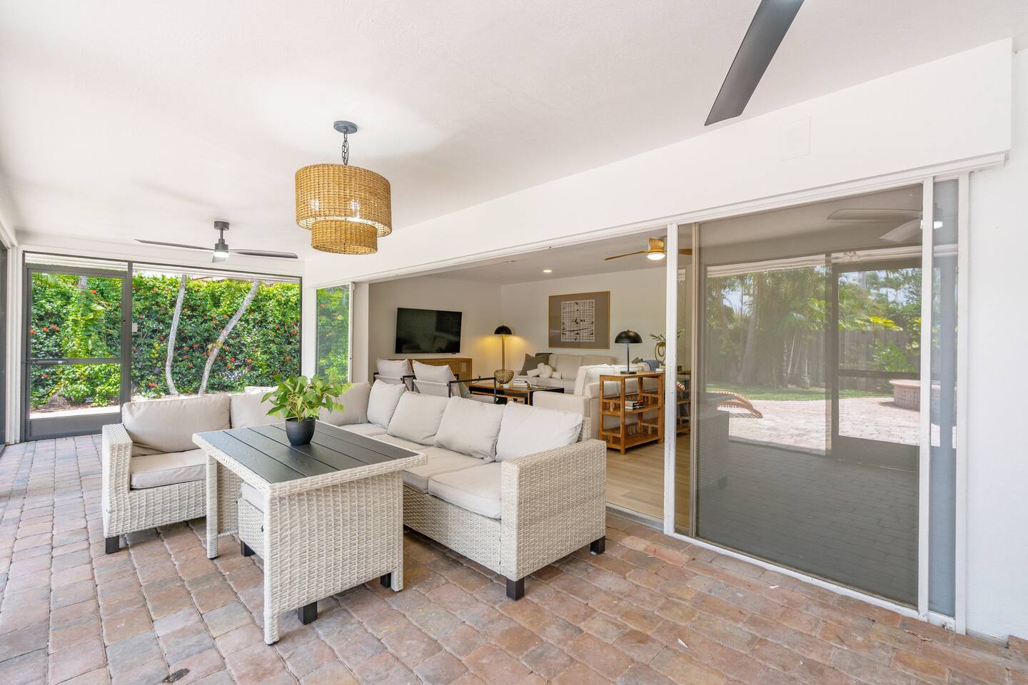 Spacious covered and screened in lanai with outdoor dining space. (Two additional outdoor benches pull out from under the table)