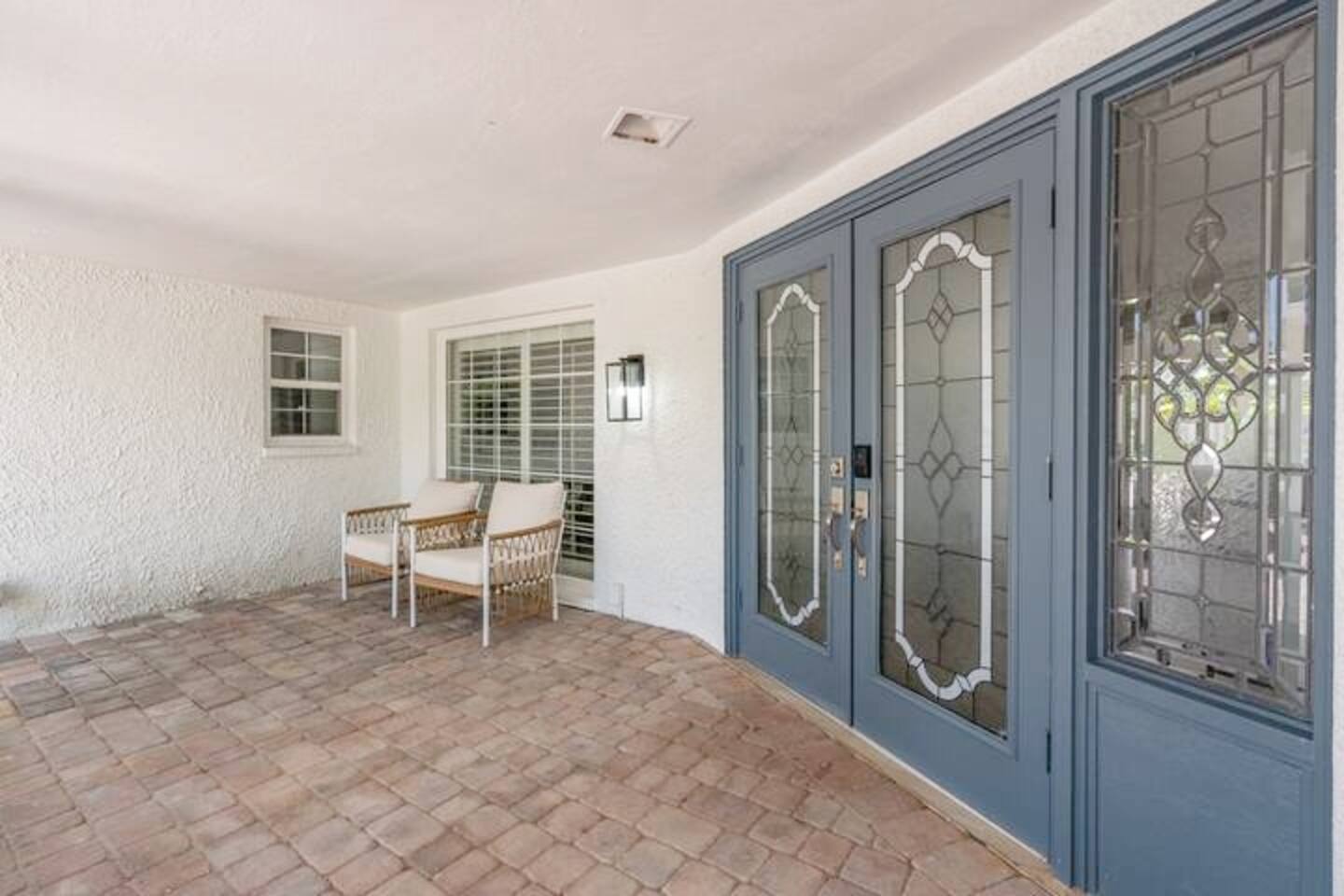 Entry with screened in patio and seating.