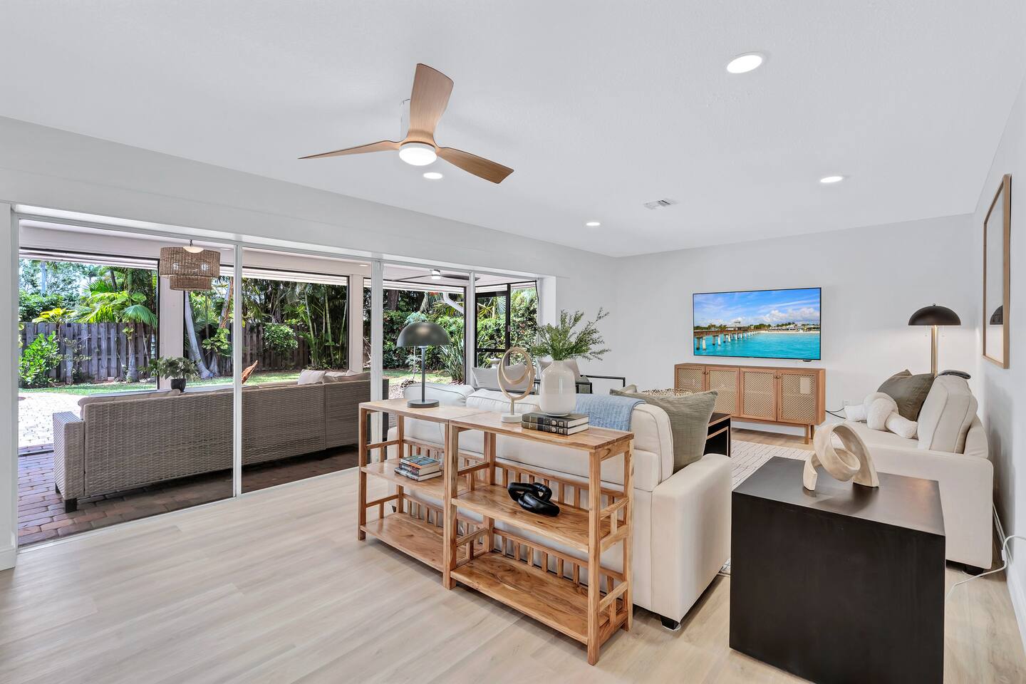 Living room with 2 pull-out sofa beds and lanai access.