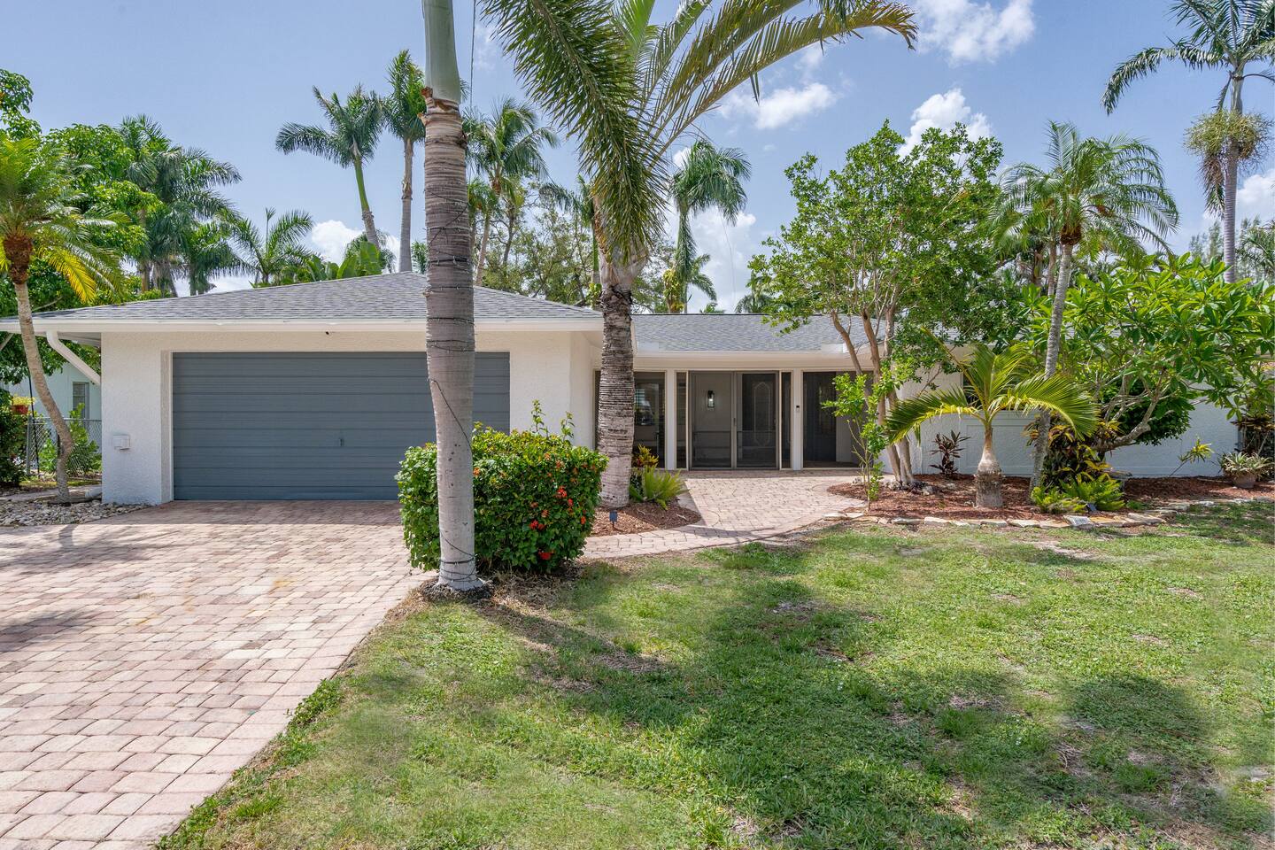 Beautiful exterior featuring solar up lighting, fruit trees and mature landscaping.