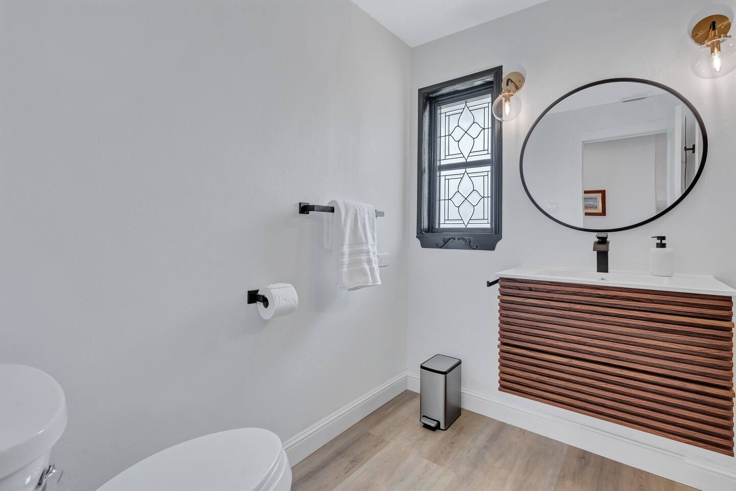 Hall Bathroom with tiled walk-in shower and floating vanity.