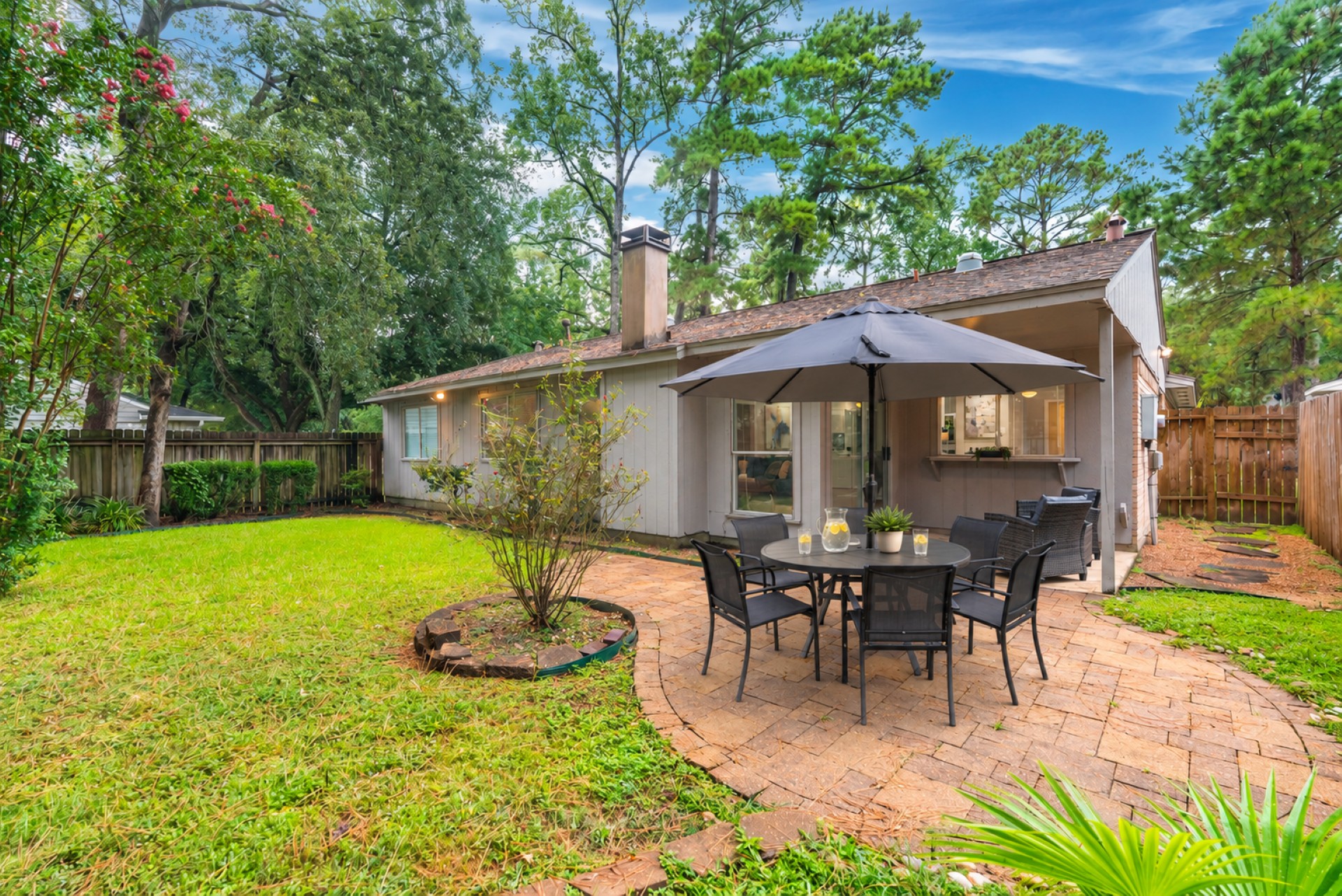 Private fenced backyard with patio dining and relaxing outdoor seating