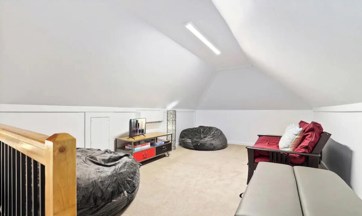 Above the garage, you'll find another lounge area with a futon, two bean bag chairs and a 24-inch Vizio Smart TV.