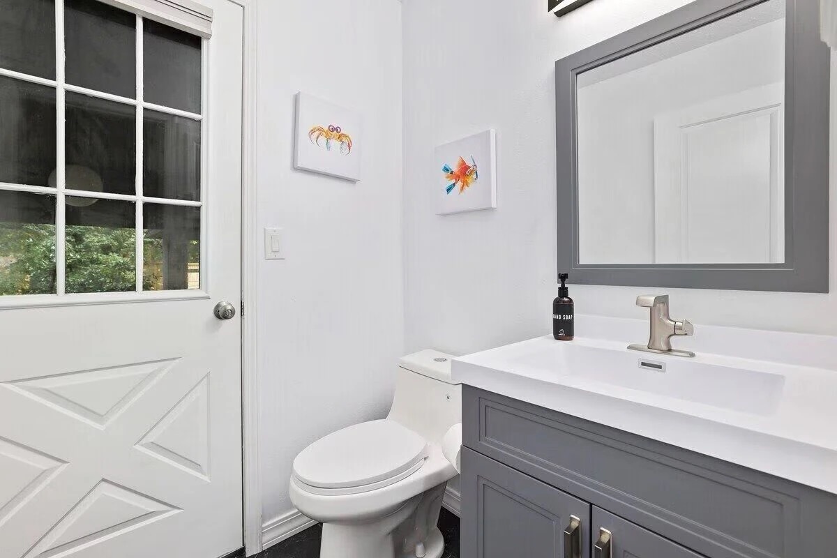 Our half bath can be found between garage and kitchen with access outside—perfect for the pool.