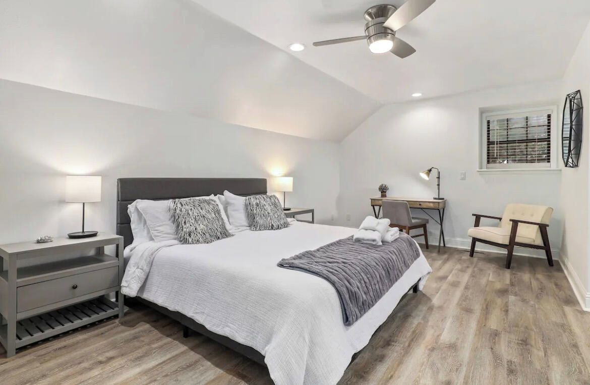 Our first bedroom is complete with a King-size bed, walk-in closet, 50-inch Smart Vizio TV, desk area, accent chair and en suite bath.