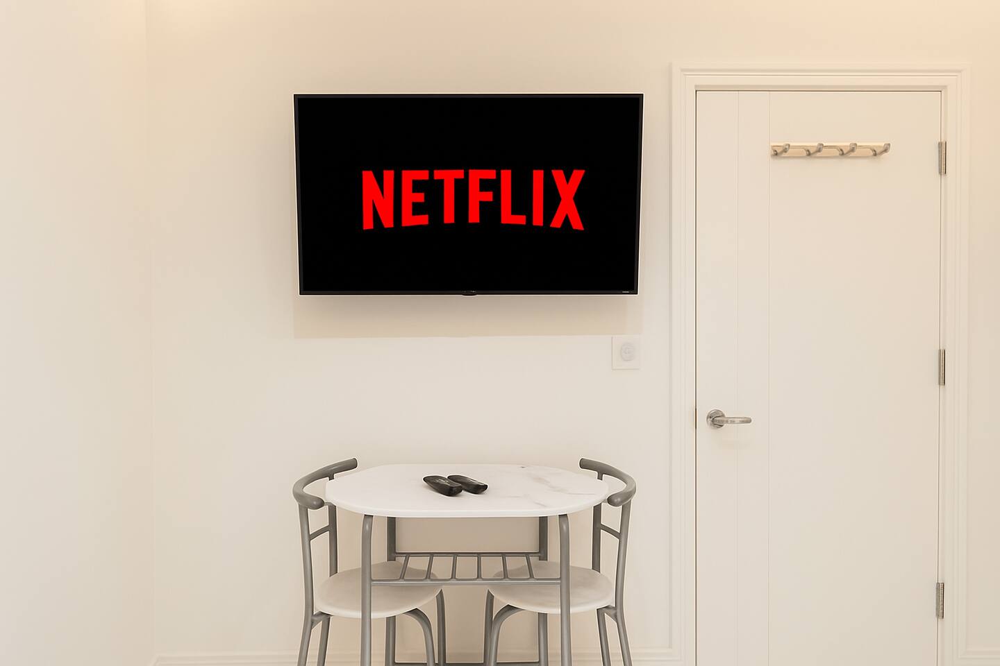 Relax with Netflix on a Smart TV in this cozy, modern dining nook for two.