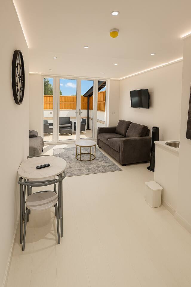 Bright living room with sofa, TV, and patio access through large glass doors.
