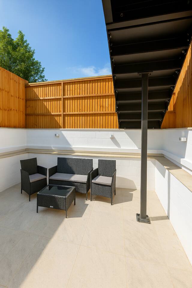 Sunny private patio with modern seating, perfect for relaxing or outdoor drinks.