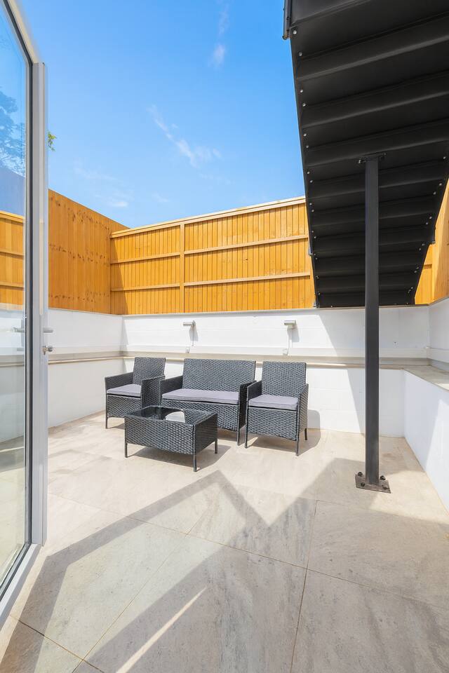 Private sunny terrace with outdoor seating, perfect for relaxing or morning coffee.