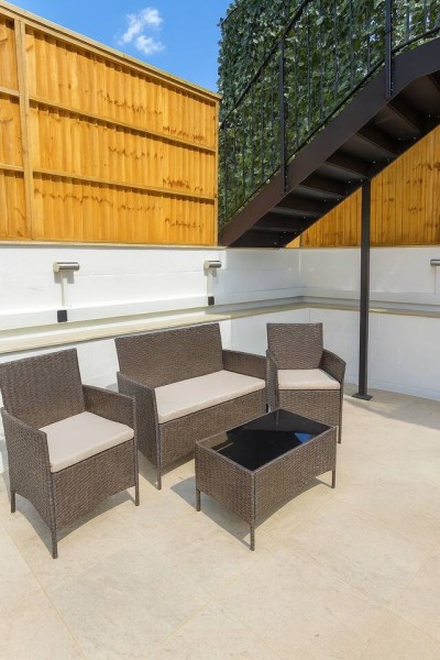 Stylish patio with cozy seating, perfect for relaxing or entertaining.