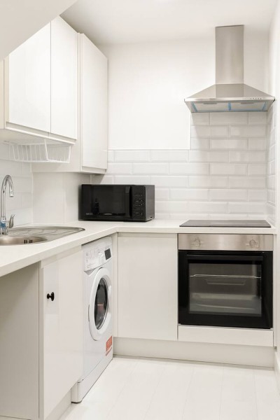 Modern, well-equipped kitchen with a built-in oven and convenient washing machine.
