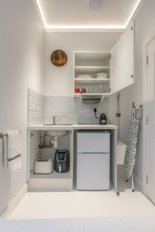 Compact kitchenette with essential appliances and clever storage for your stay.