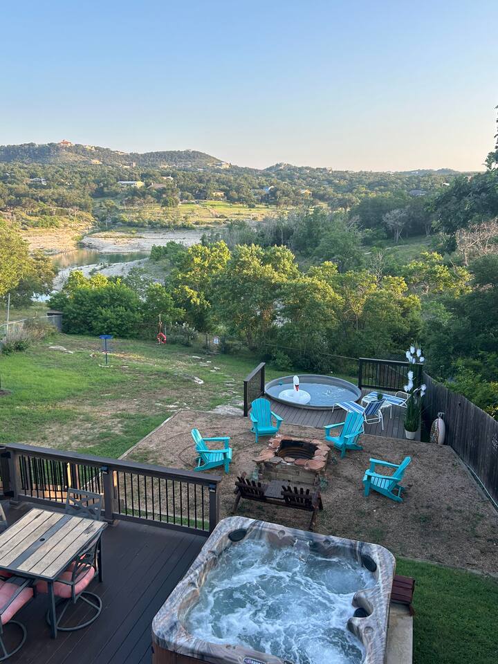 View from the top deck: hot tub on level 2, fire pit and stock tank pool below