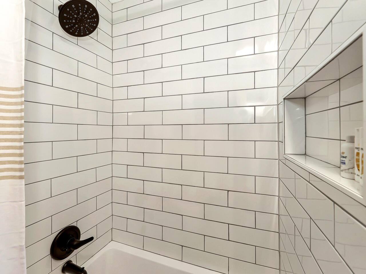 Subway tile lines the functional tub. Enjoy a soak or the warmth of a long shower! Starter shampoo, conditioner and body wash are provided for your stay.