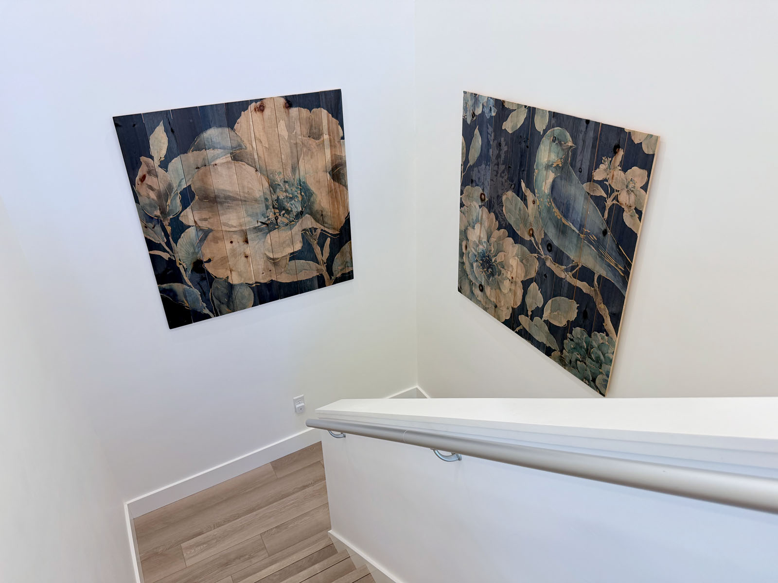 Bright modern stairwell with elegant floral and bird wall art
