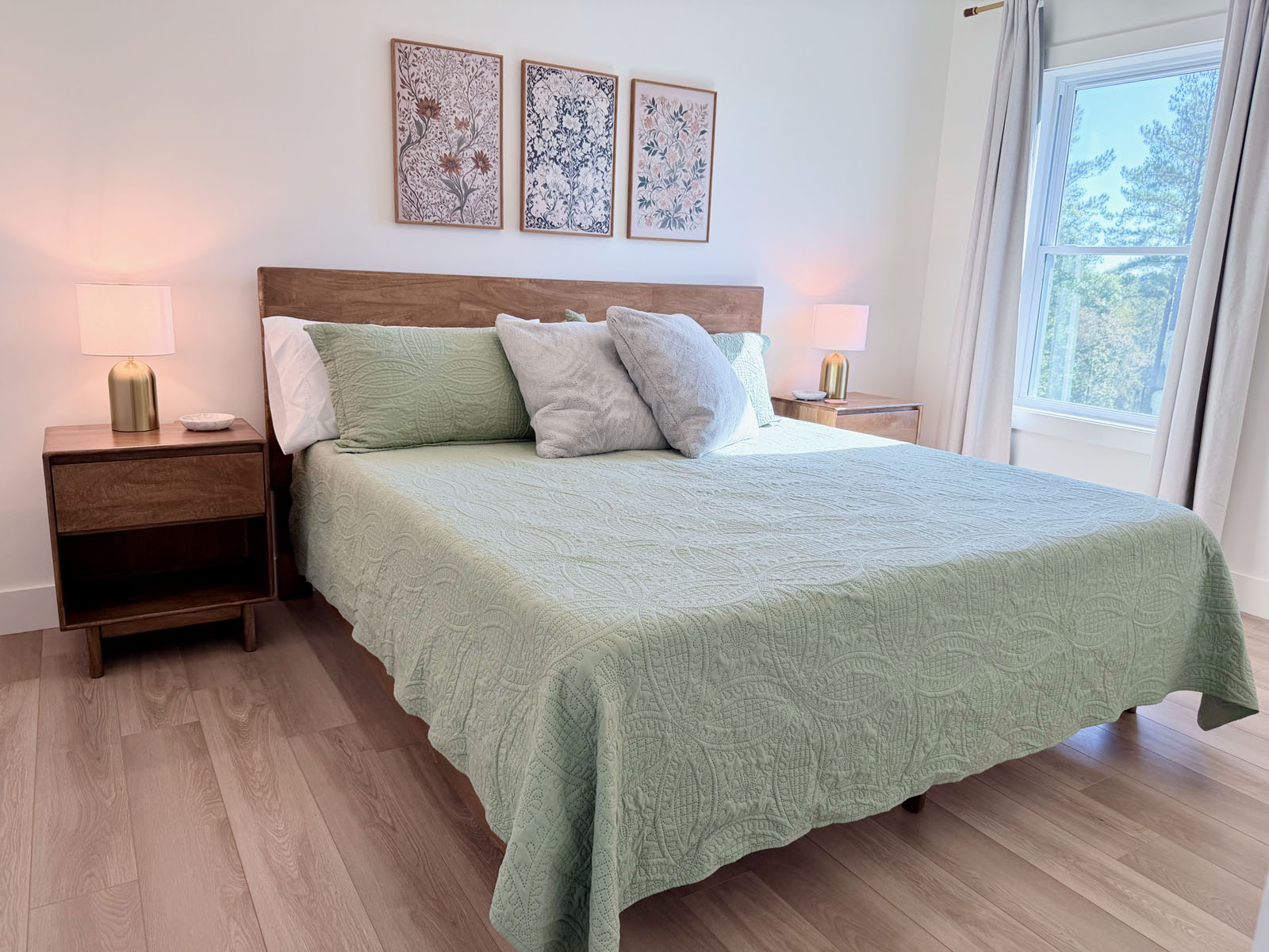 Bright, serene bedroom with tree views and cozy modern touches