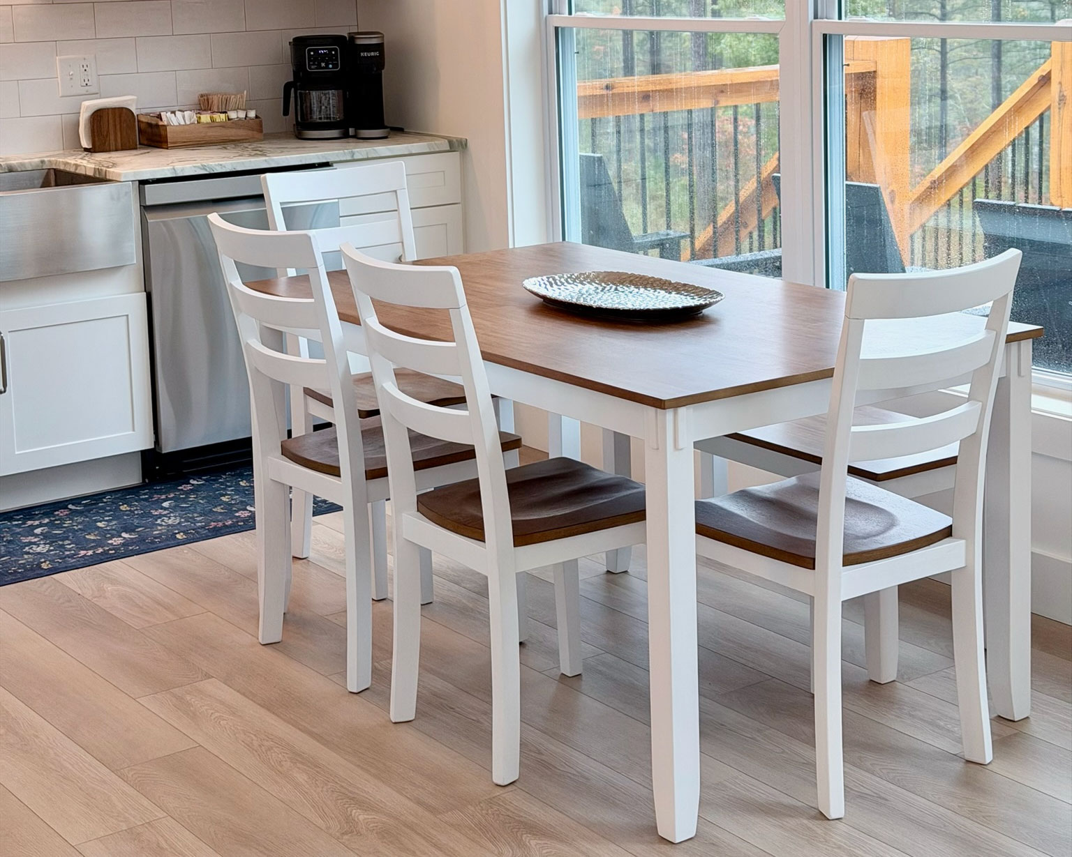 Bright dining nook for 4 with big windows and peaceful deck views