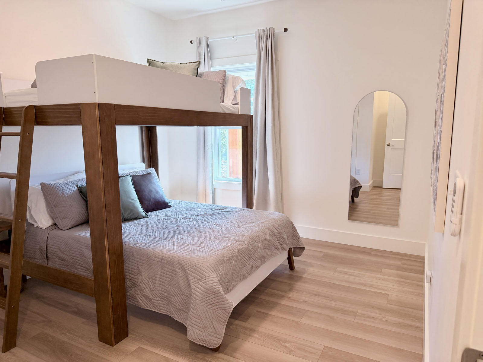 Bright family-friendly bedroom with bunk-style beds and modern finishes