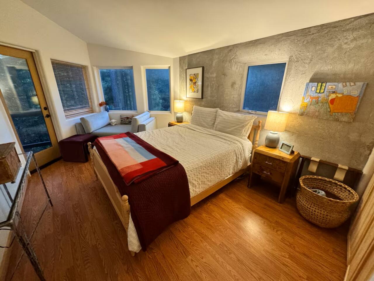 Relax in comfort with plush bedding and forest views.