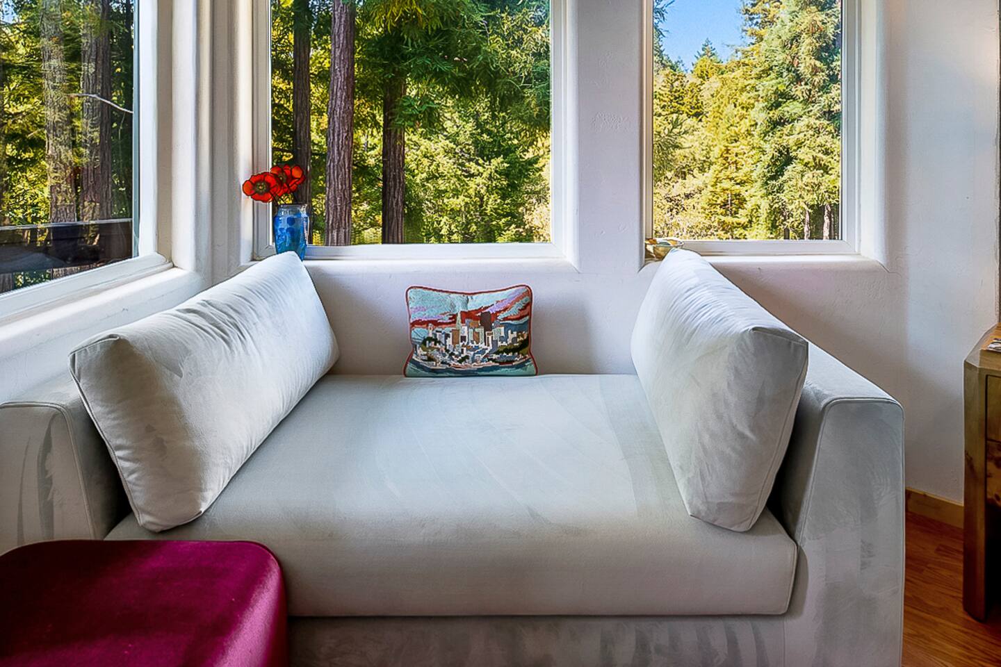 Bright corner bedroom with wraparound windows and private balcony.