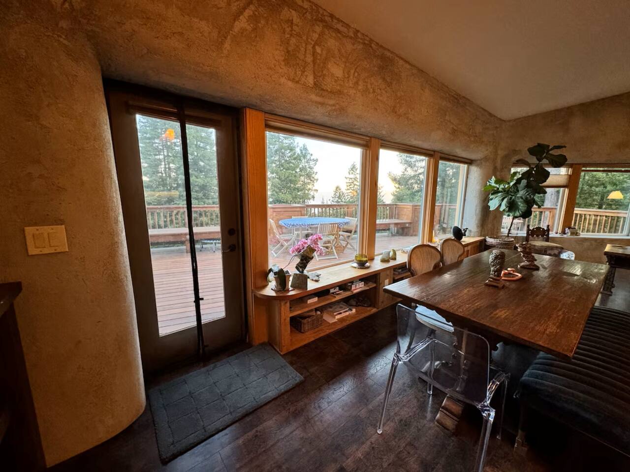 Dining space with big windows and forest views — perfect for shared meals.